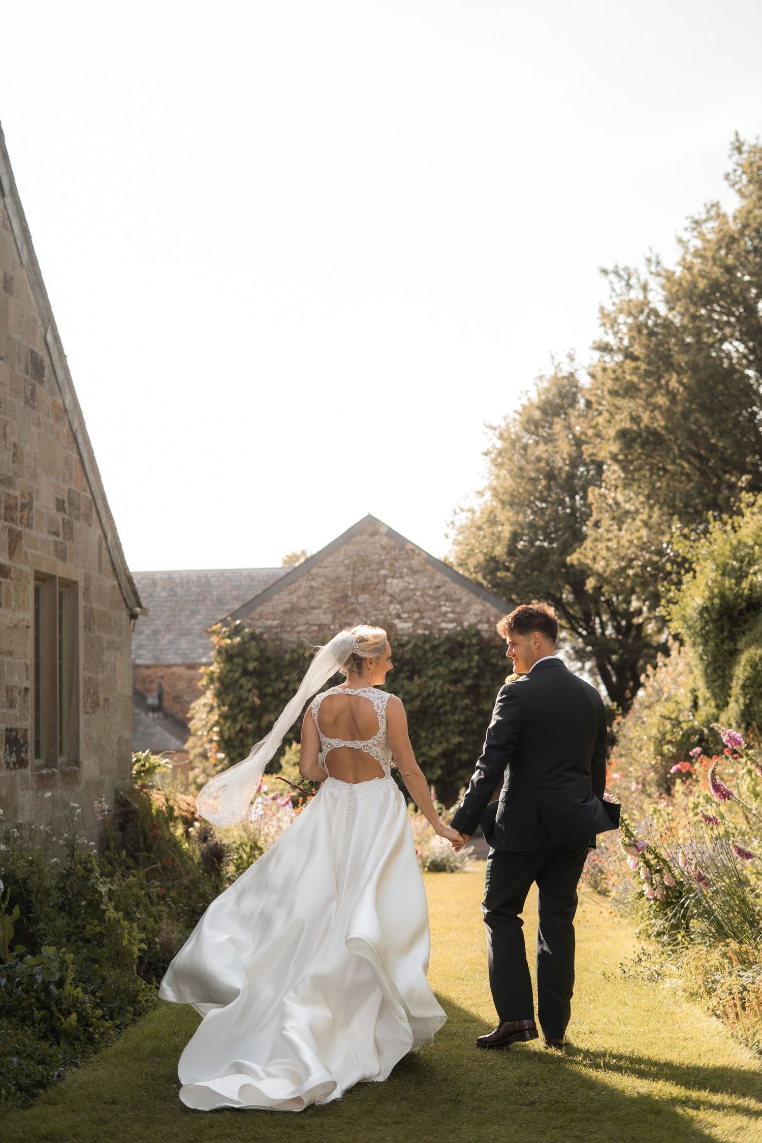 Bride and groom portrait by Sander-Long Photography, a Newquay wedding photographer. Bridal gown from Bliss Bridal Gowns, Nansledan