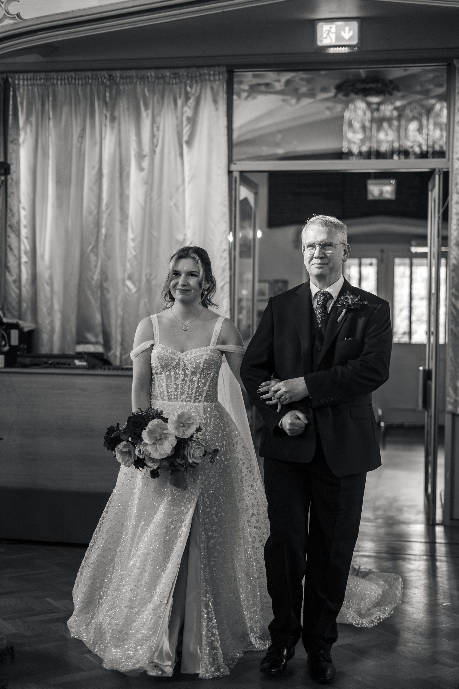 Bride being walked down the isle by her father during a church wedding in Cornwall