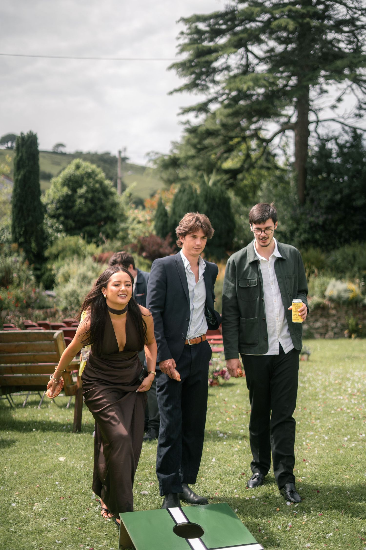 Wedding guests playing Cornhole in the garden