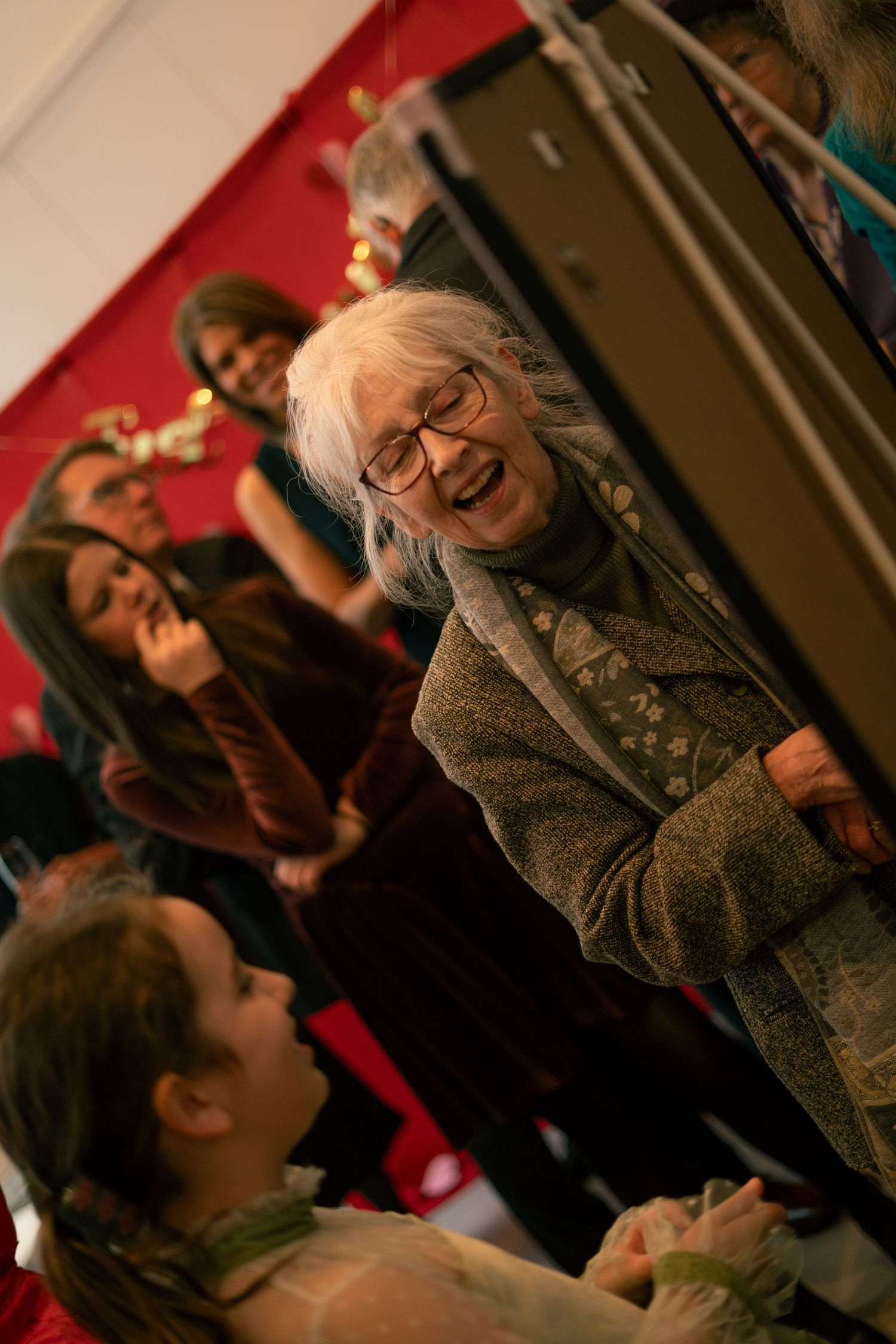 Candid photo of grandparent laughing during wedding reception in Cornwall