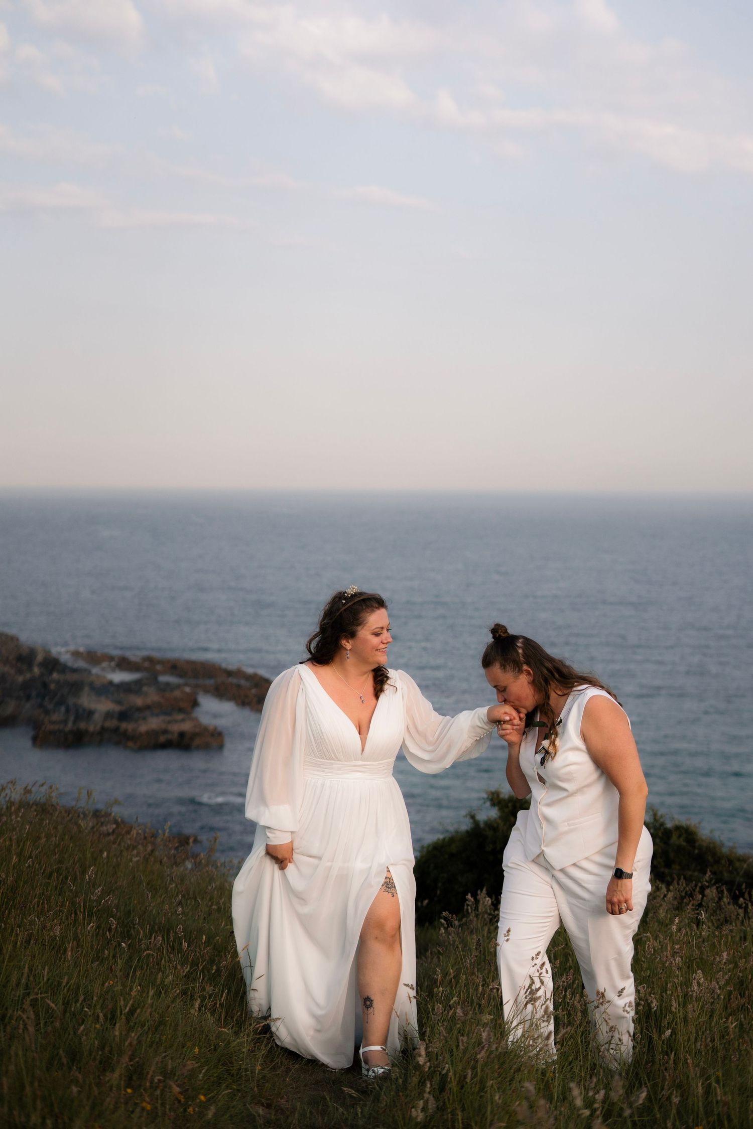 Two brides celebrating their Tredudwell Manor wedding on the shore of Lantic Bay in Cornwall