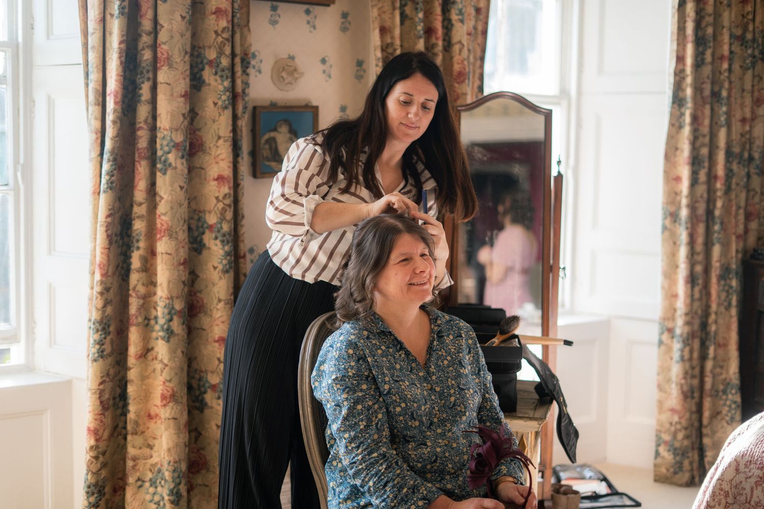 Mother of the bride having her hair and makeup done on a wedding morning in Cornwall
