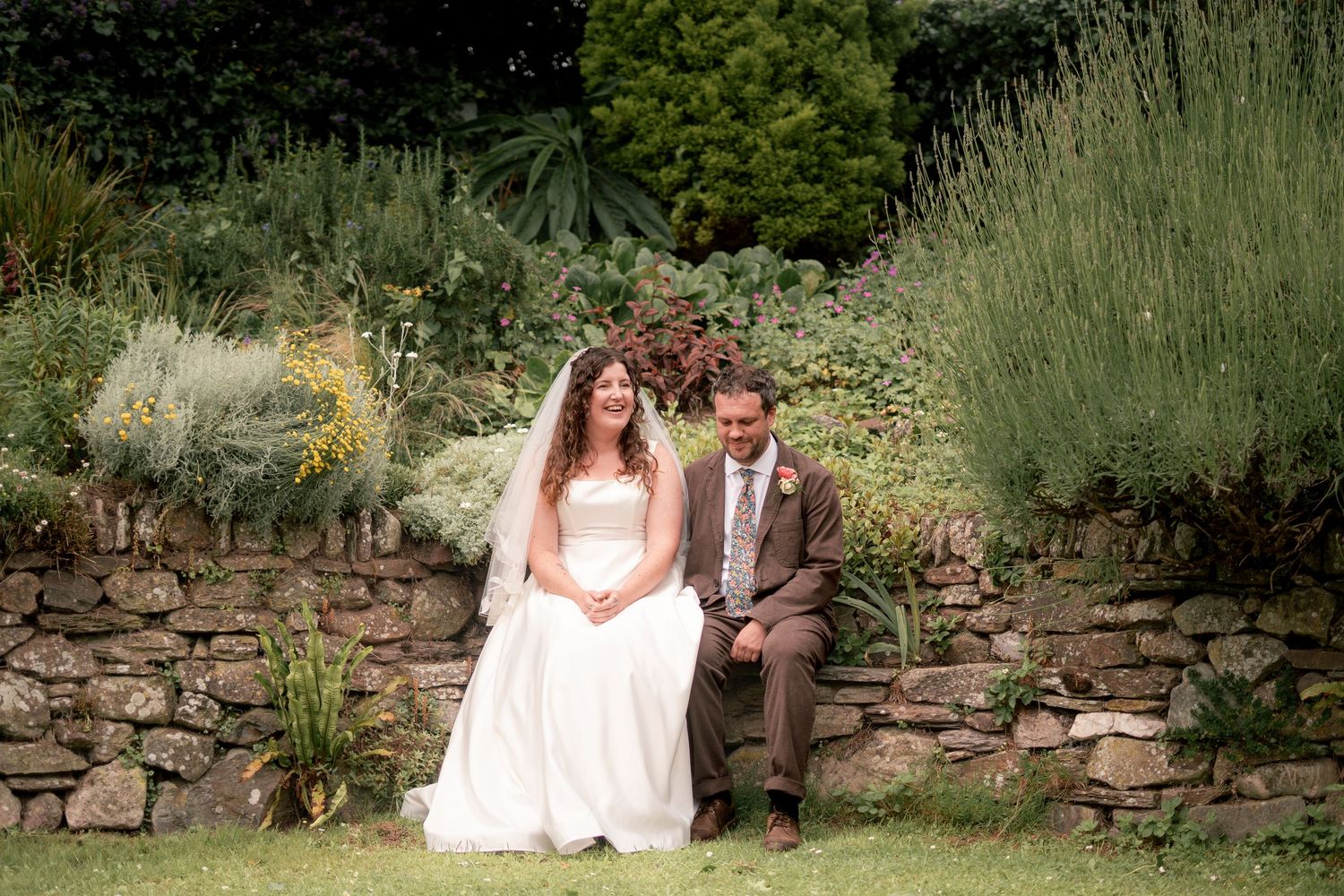 Bride and groom laughing during their wedding ceremony in Cornwall