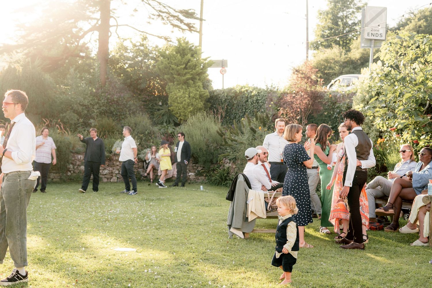 Wedding guests in the garden of a relaxed wedding in a small Devon village