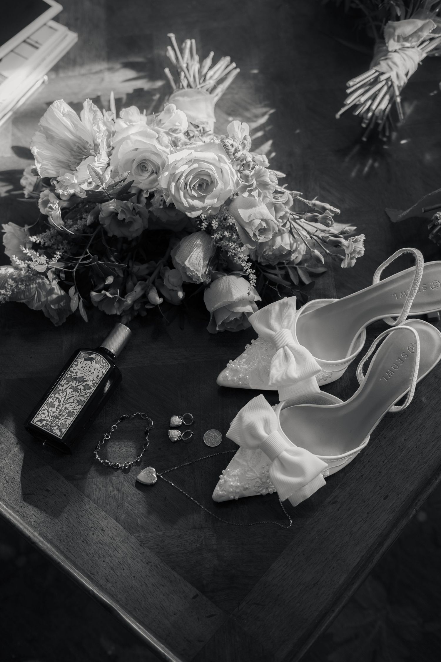 Black and white editorial of wedding day details arranged in a flat lay