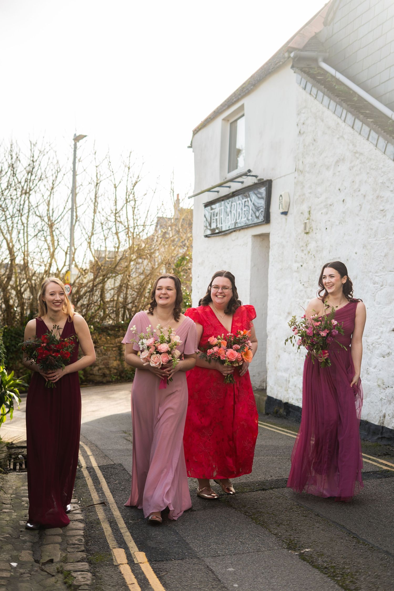 Bridal party walking through the Cornish streets of Penzance, on the way to the church