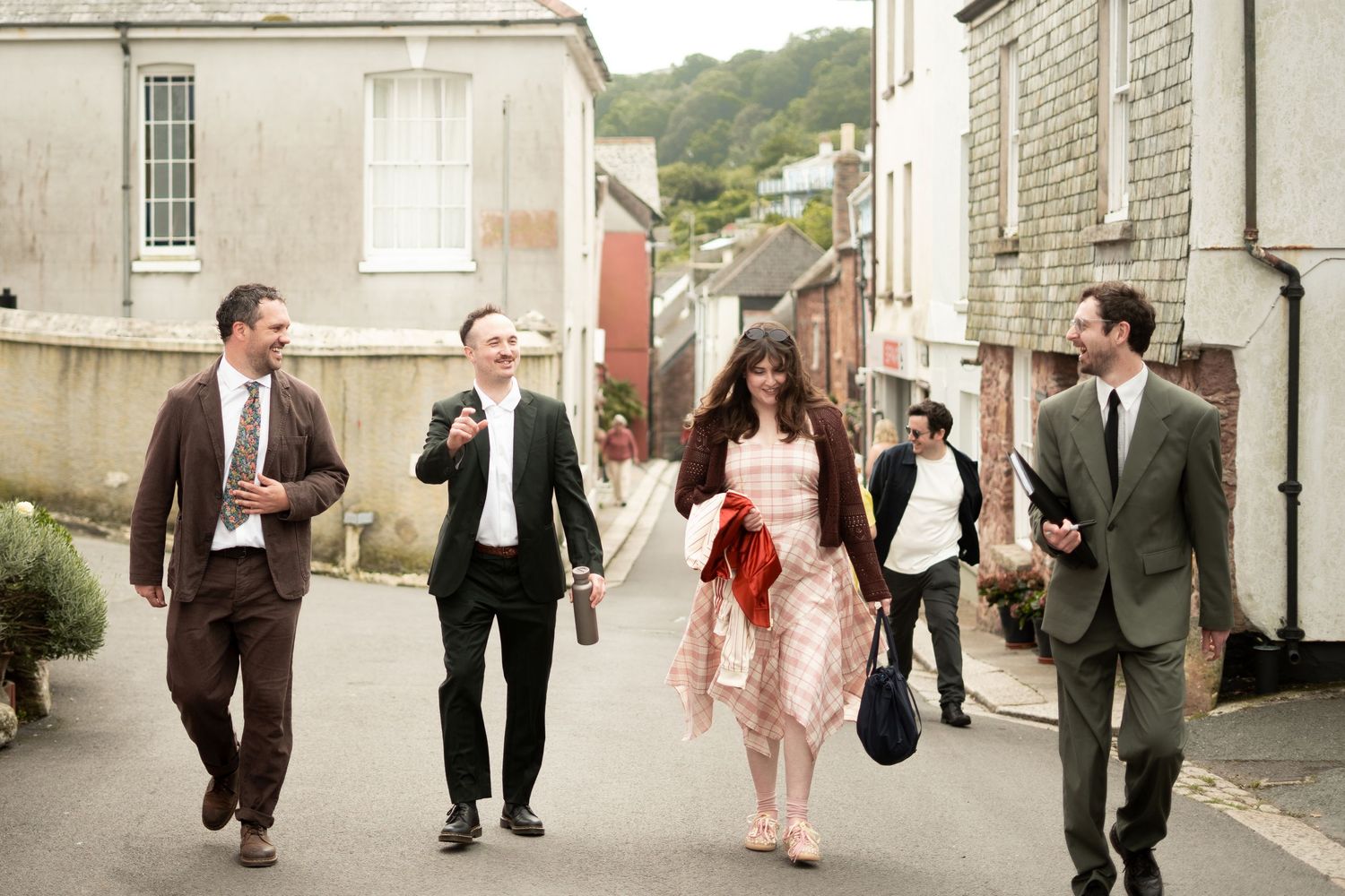 Groom walking through the village towards Maker with Rame Community Hall, Kingsand, Cornwall