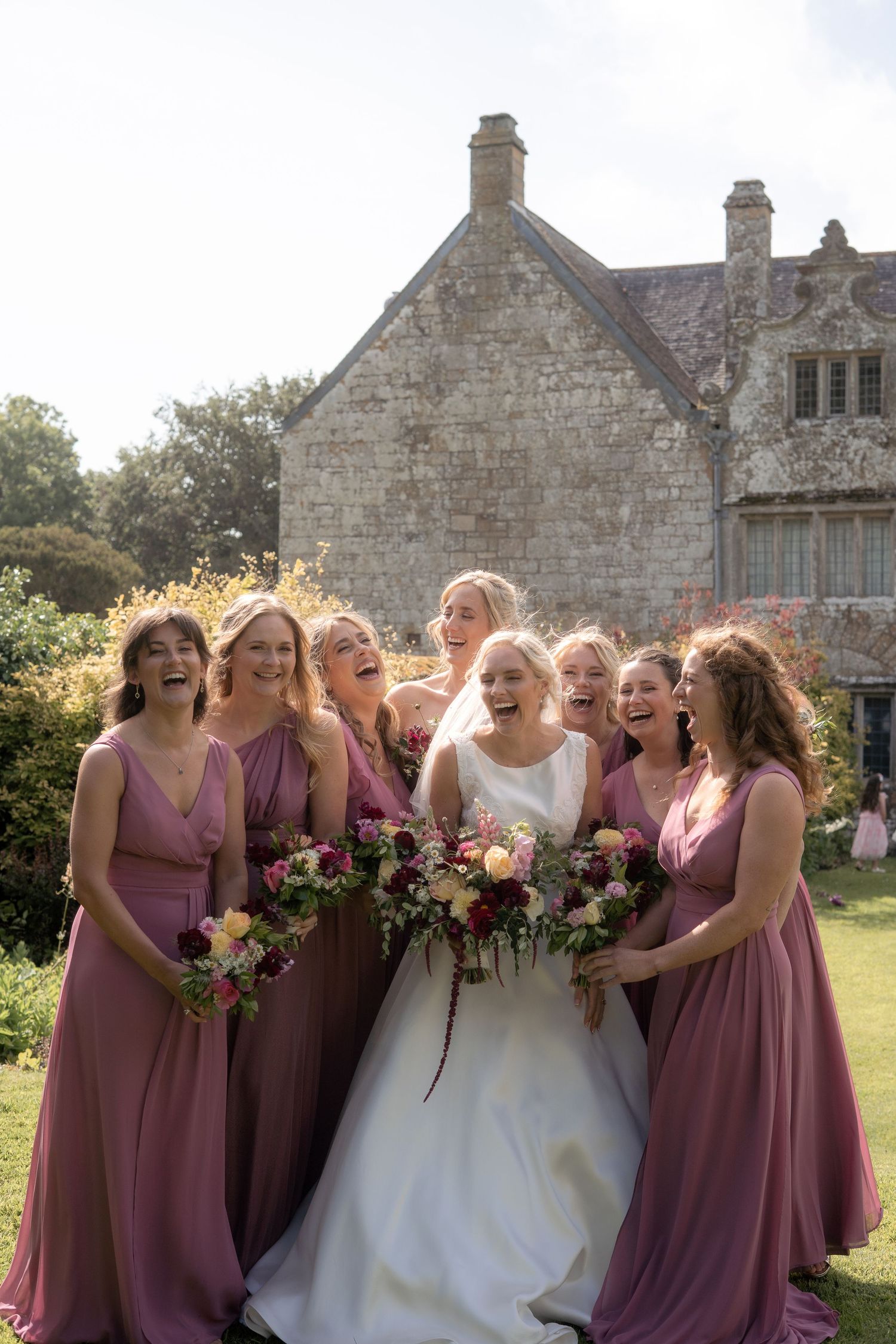 Bridesmaid photo with the bride wearing her dress from Bliss Bridal Gowns