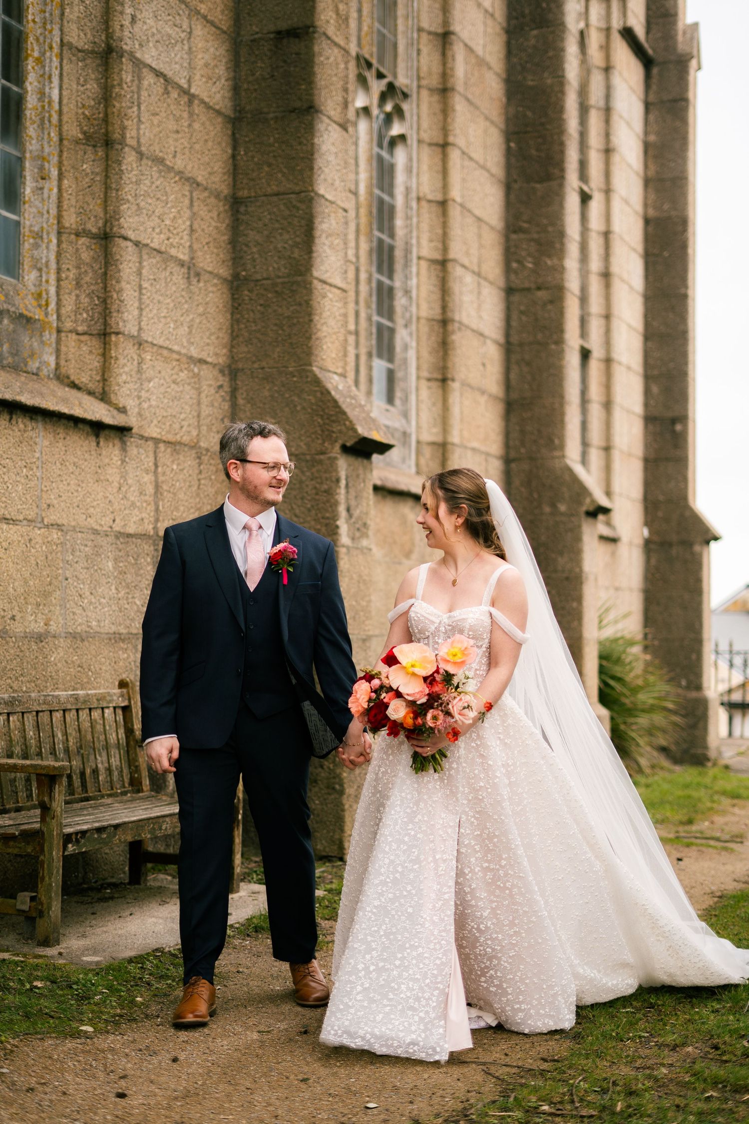 Candid portrait of bride and groom outside Penzance Church on their wedding day