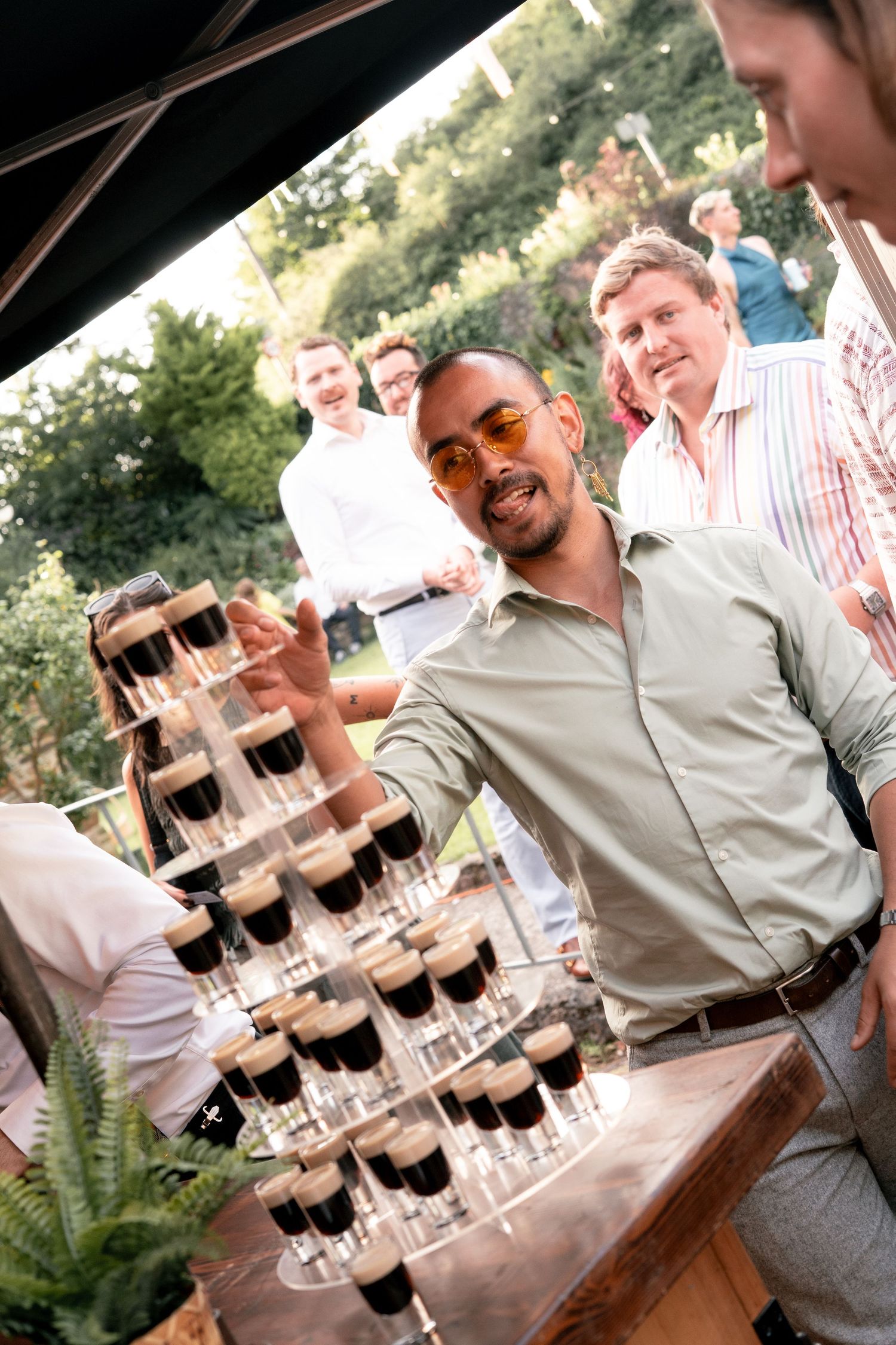 Guests enjoying the bar at a garden party wedding