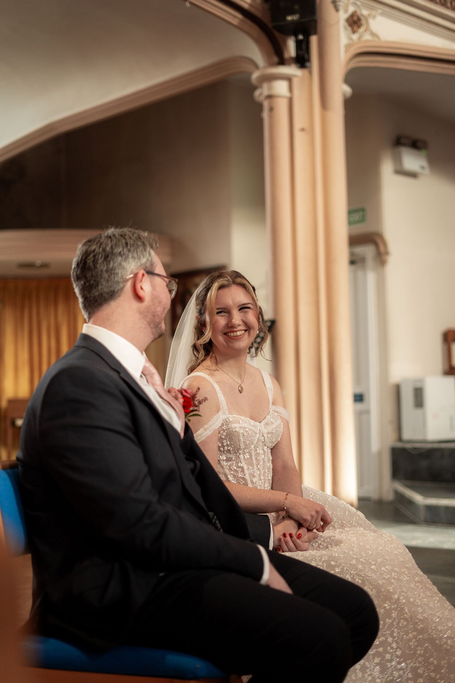 Candid photo of the bride looking at the groom during church wedding in Penzance, Cornwall