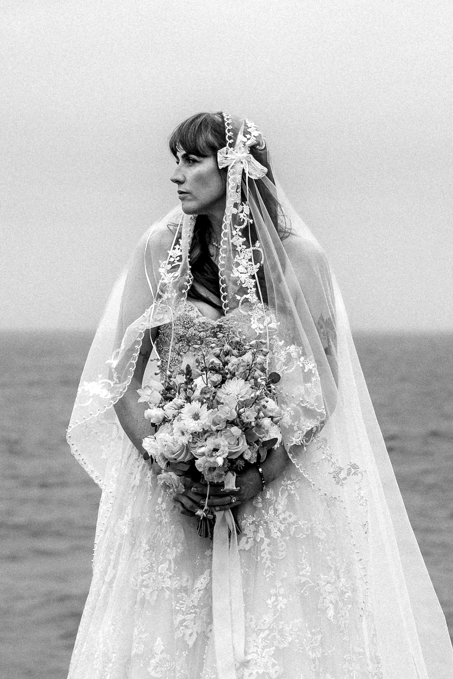 Black and white editorial bridal portrait on the coast of Cornwall