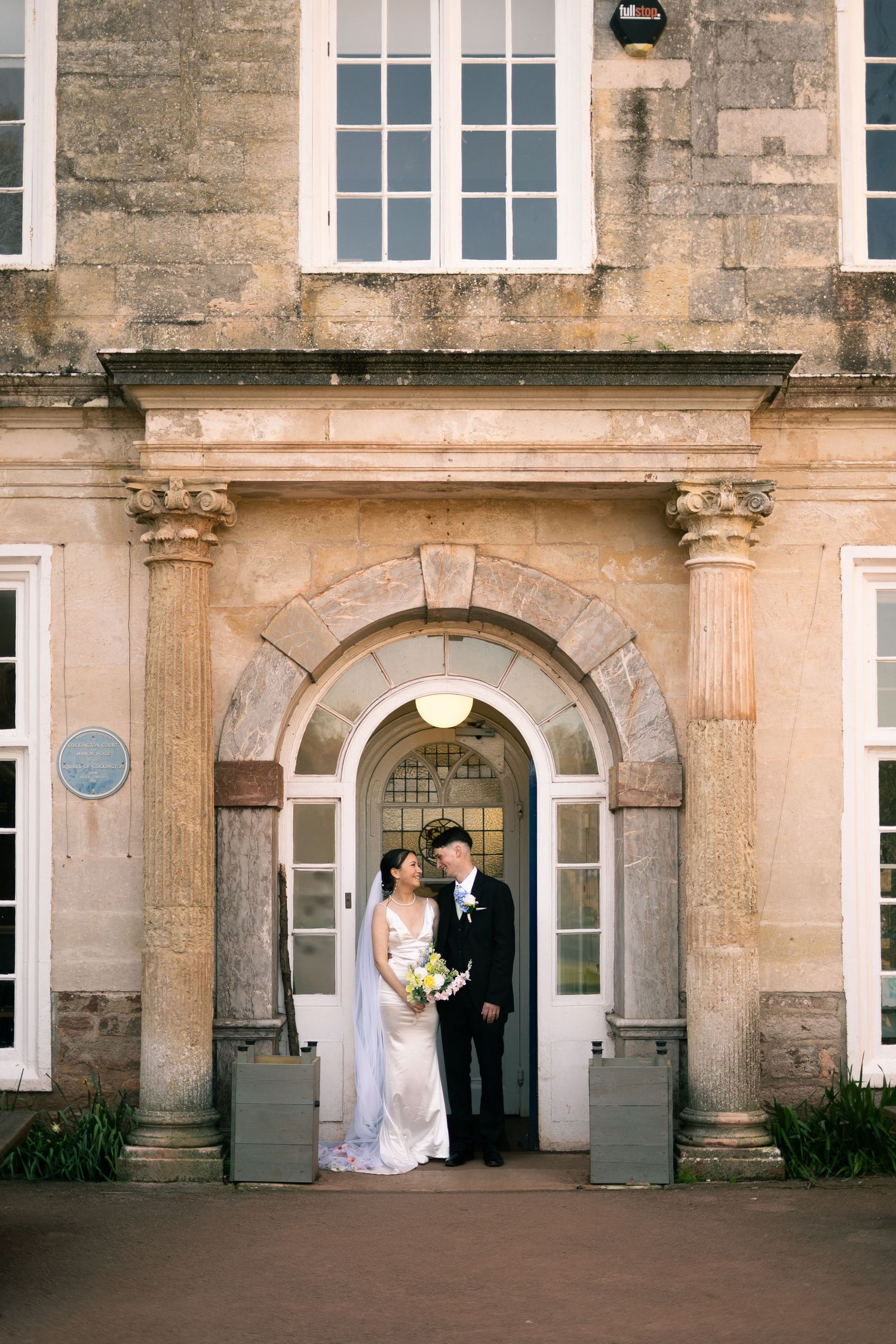 Bride and groom editorial portrait at Cockington Court registry office, Devon