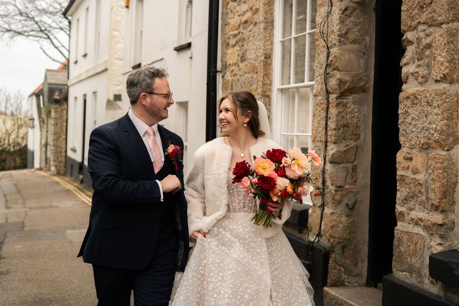 Bride and groom walking through the Cornish streets of Penzance