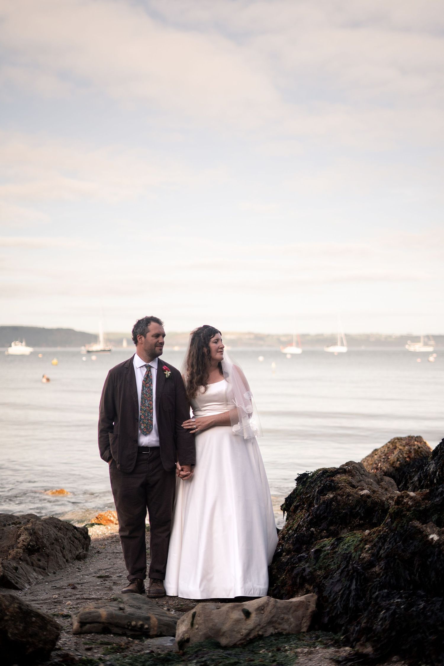 Editorial style photo of bride and groom on the beach in Cornwall