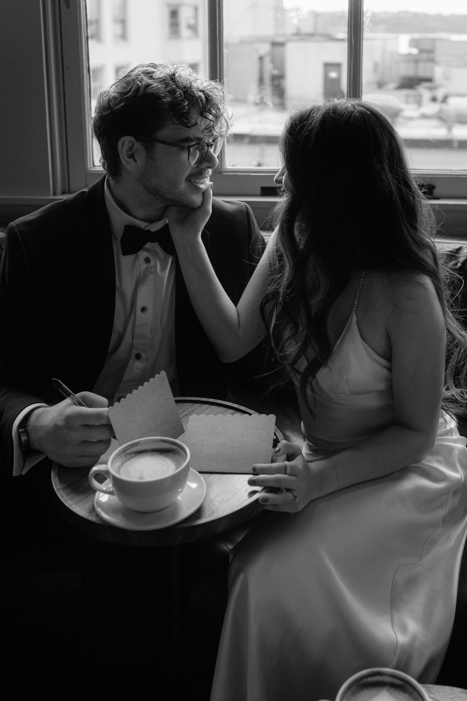 A romantic black and white sequence shows a couple sharing an intimate moment at a restaurant table.