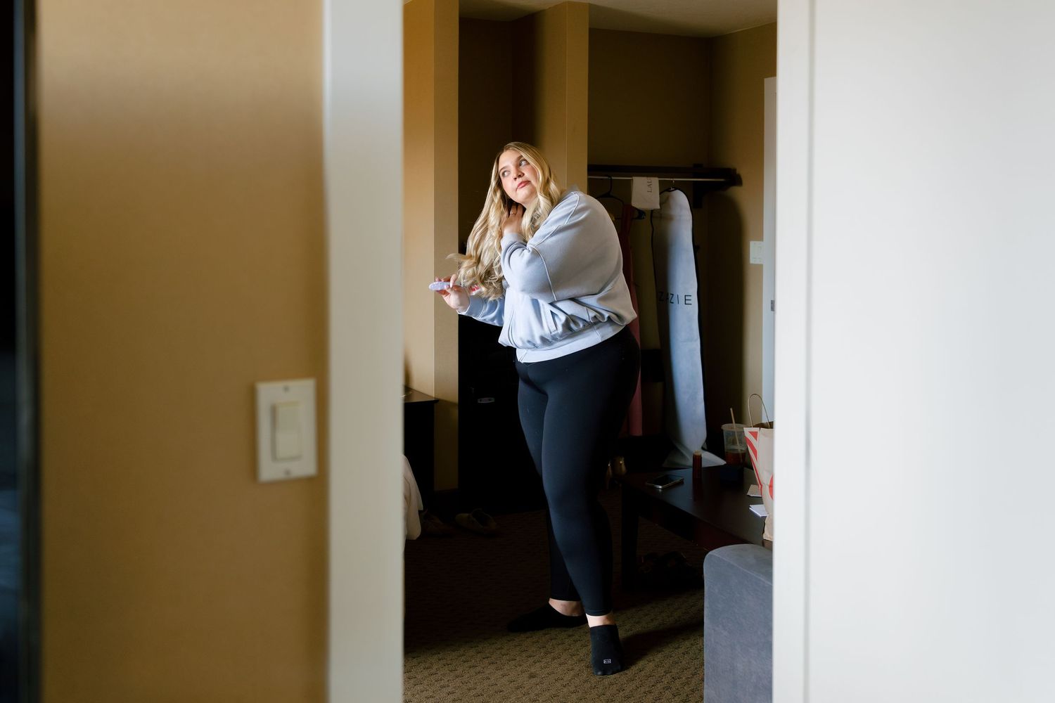 A series of indoor hallway shots showing movement and preparation in what appears to be a residential space.