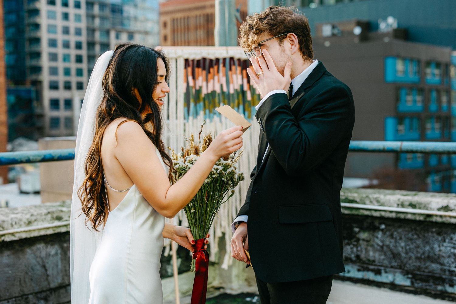 Dancing couple on rooftop with Seattle skyline visible in background.