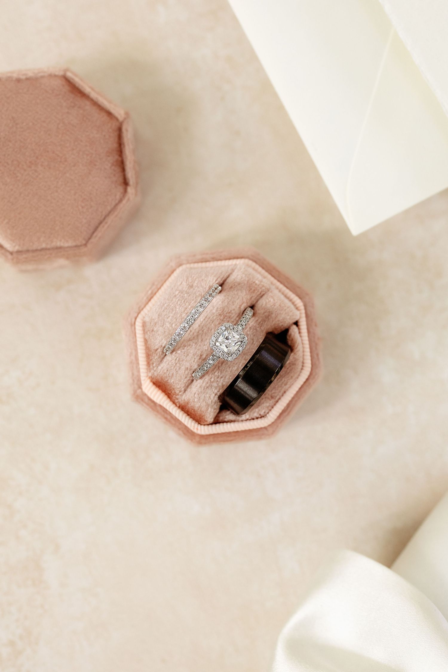 Pink velvet ring box with sparkling diamond engagement ring nestled inside.