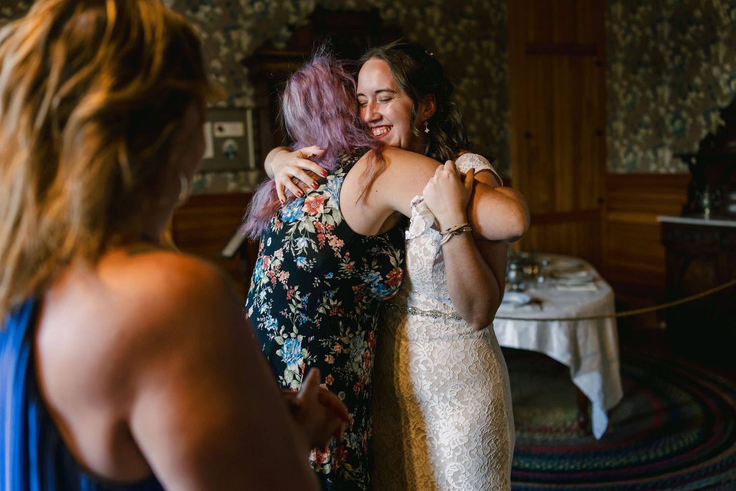 Wedding celebration candid moments captured in rustic indoor venue.