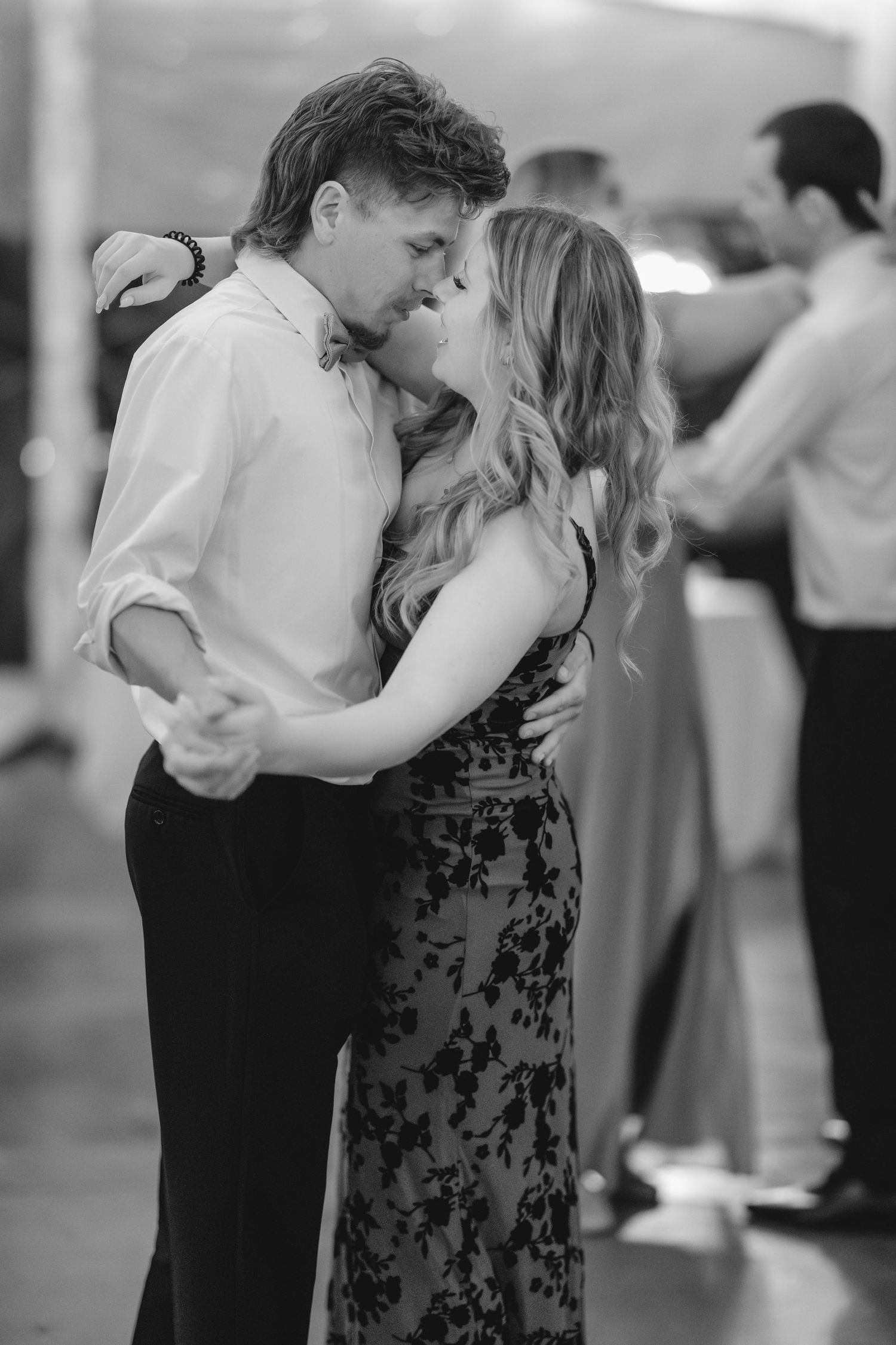 Black and white photo sequence showing couples dancing together in an intimate slow dance.