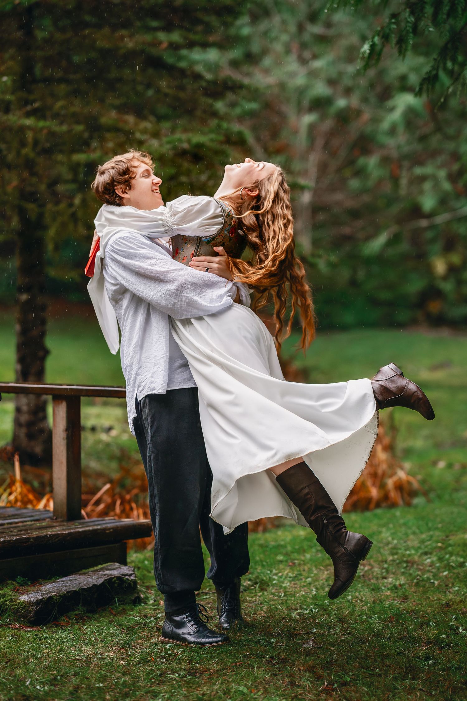 A playful dance sequence in a garden setting with flowing white dress and formal attire.
