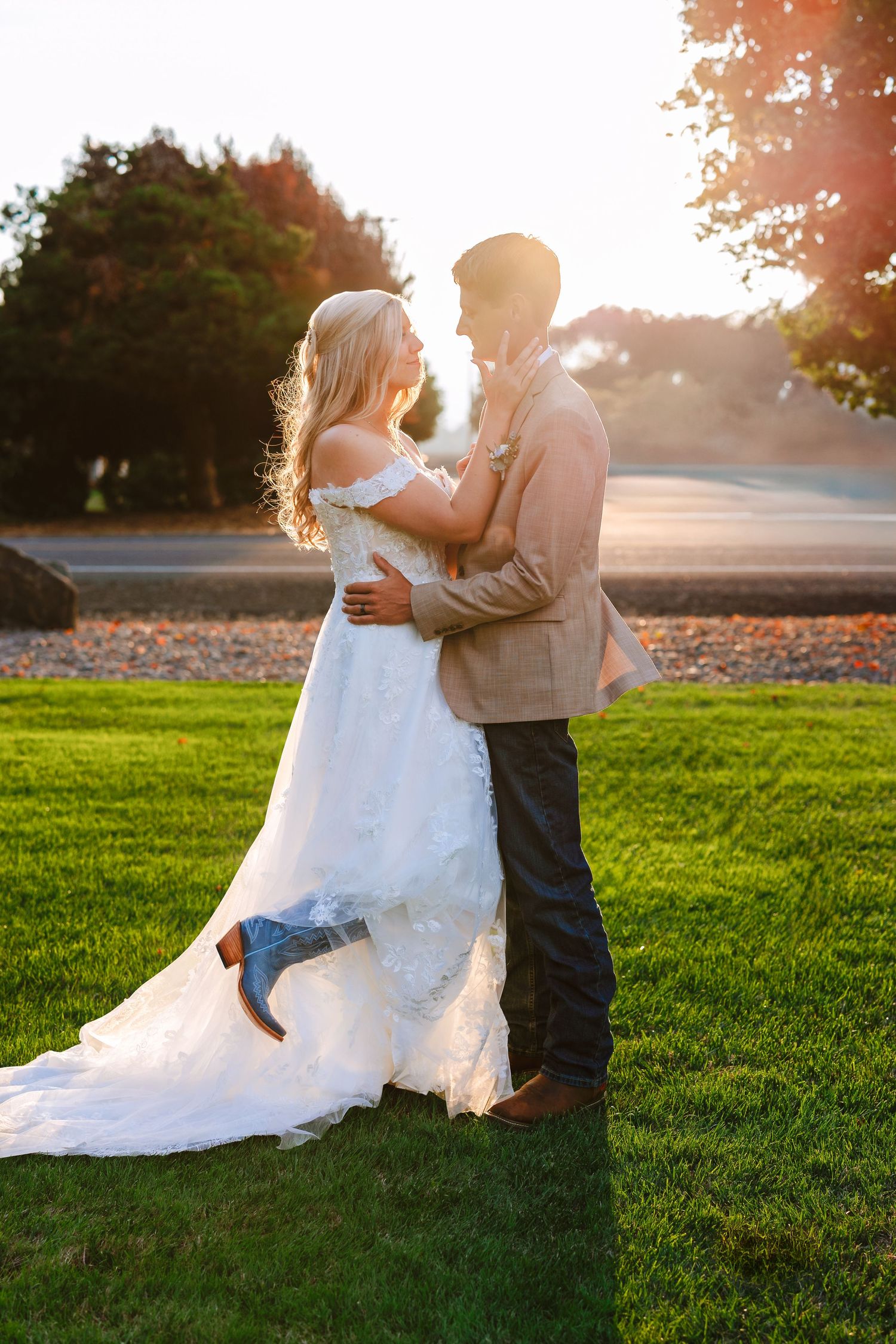 A romantic sunset wedding photo session on a lush green lawn with flowing white dress.