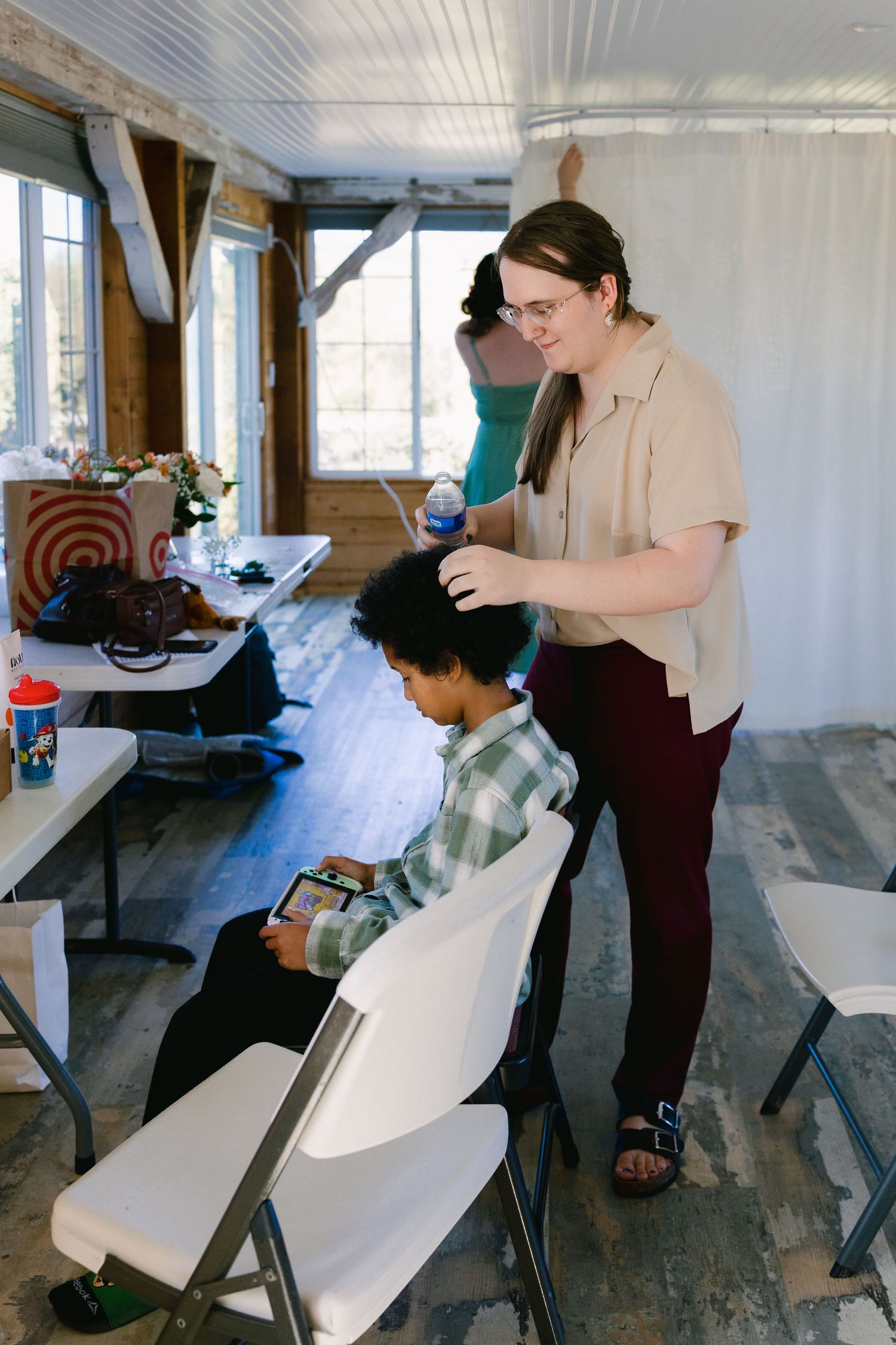 Indoor event preparation scene with folding chairs and setup activities.