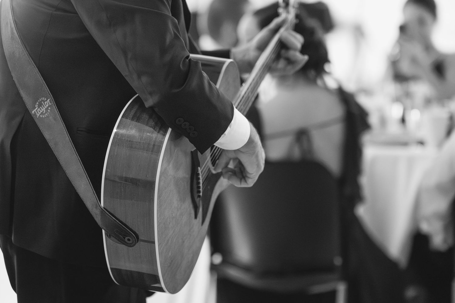 Black and white candid moments captured during wedding reception celebrations.