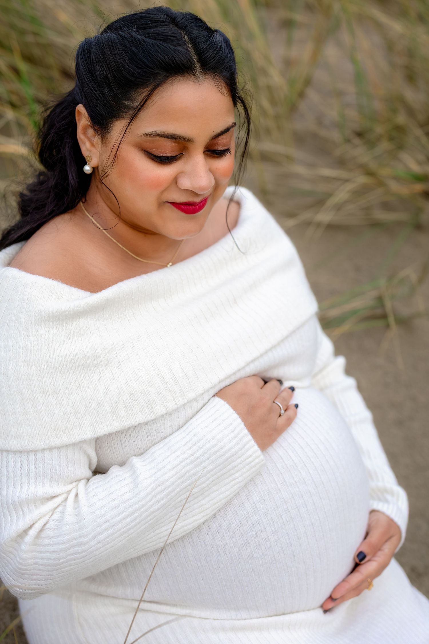A series of photos showing a person wearing a cozy white knit sweater while sitting outdoors in a natural setting.