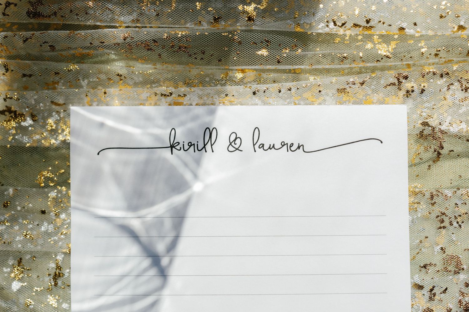 Elegant wedding invitation design with delicate calligraphy text on a textured background.