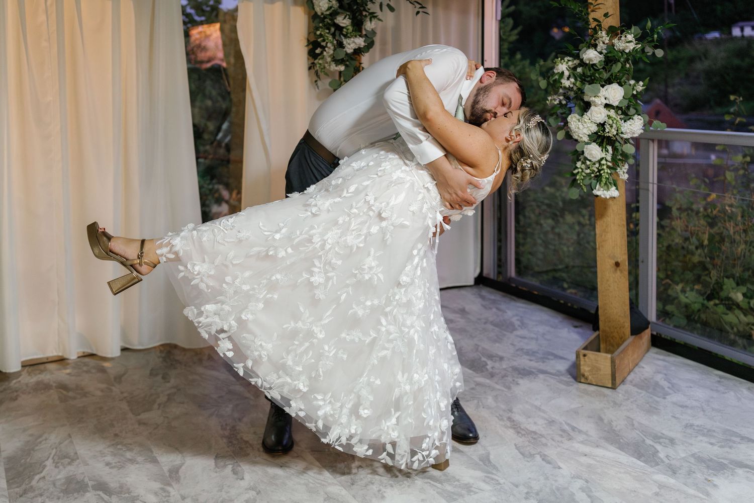 Couple performing a dramatic dip dance move on their wedding day.