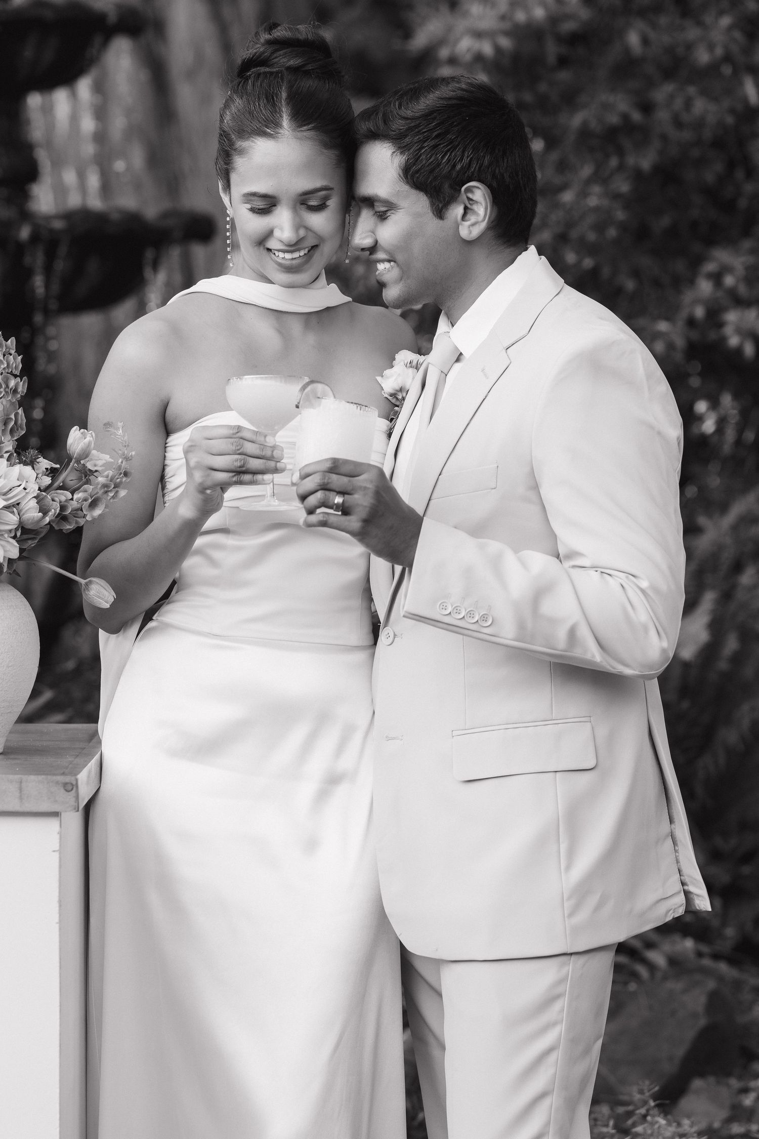A tender black and white wedding moment captured as a couple shares an intimate exchange during their celebration.
