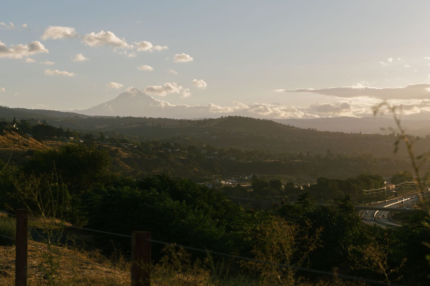 Panoramic mountain landscape view with rolling hills at sunset.
