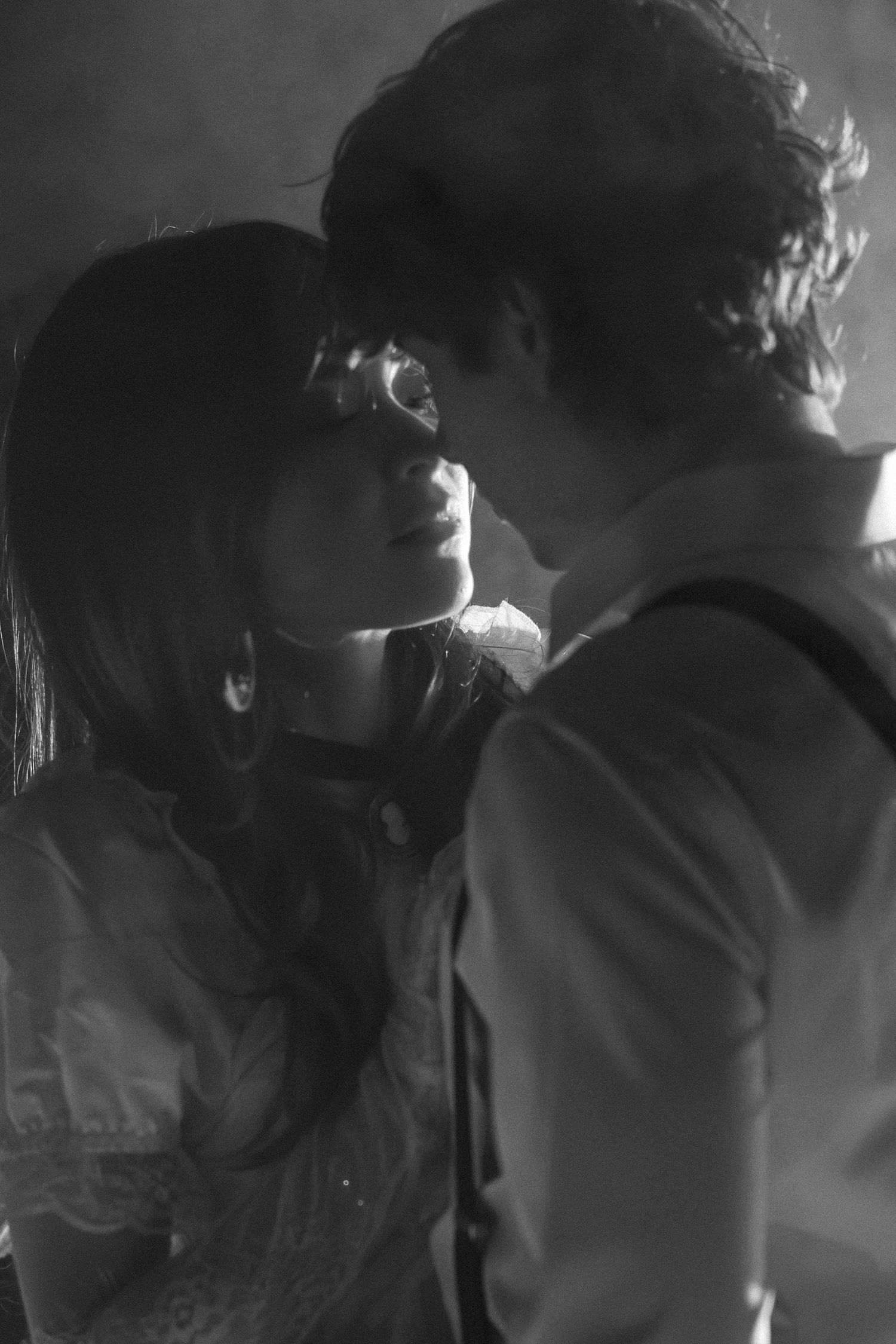 A series of black and white silhouettes showing a couple in an intimate moment, creating a romantic atmospheric scene.