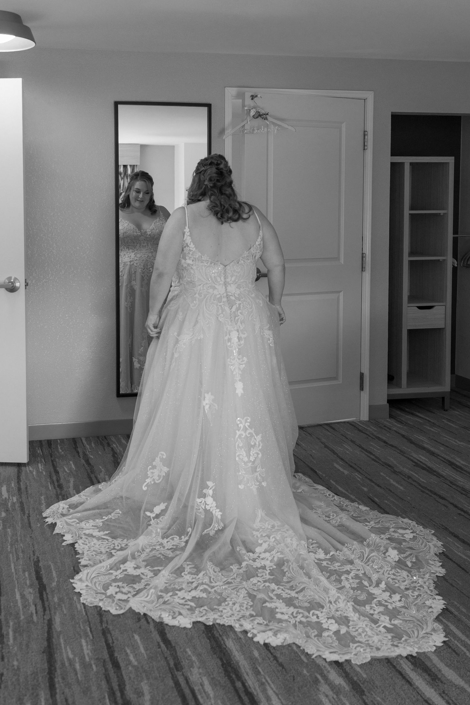 A beautiful white wedding dress with intricate lace details and a long flowing train displayed in multiple angles.