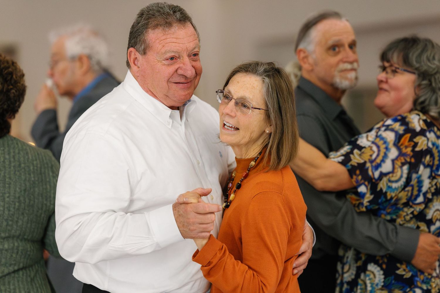 Wedding guests dance and celebrate together during a lively reception party.