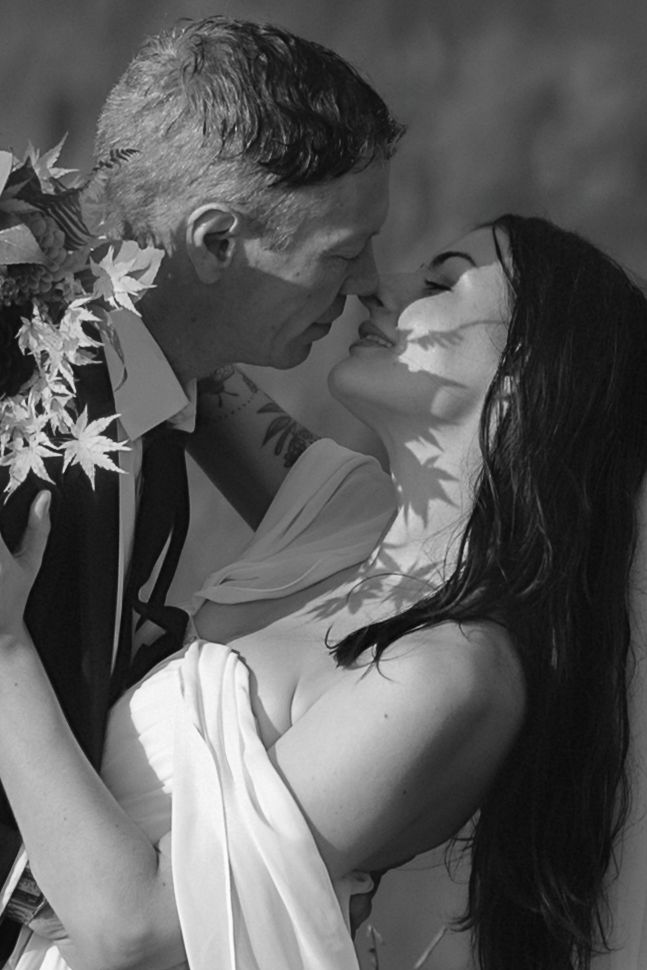 A black and white artistic photo series showing an intimate romantic moment with white flowers.