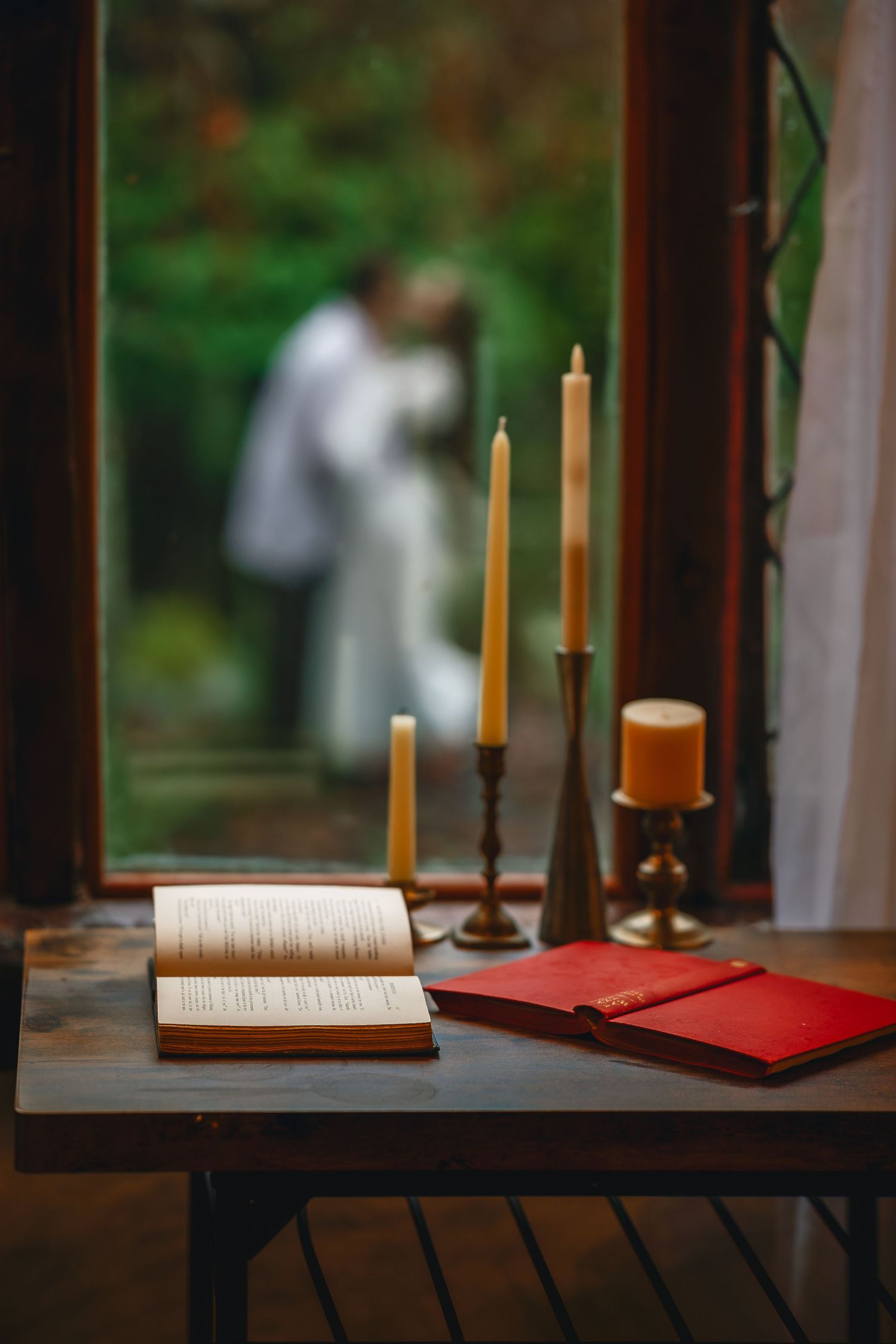 A series of five photos showing lit candles and an open book on a wooden table with blurred green background.