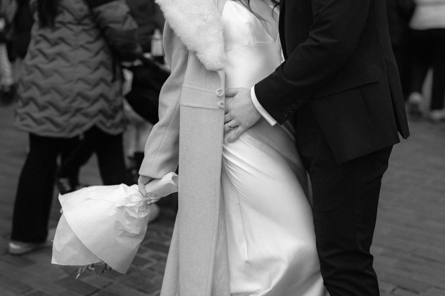 Romantic black and white sequence of a couple embracing in formal attire.