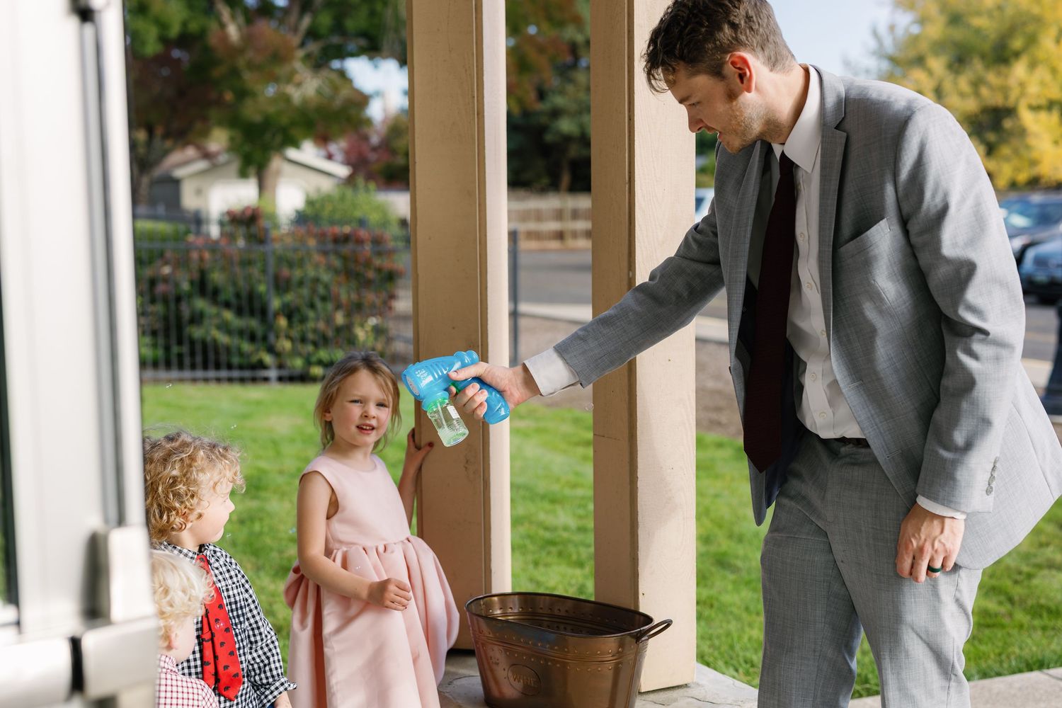 Children playing and interacting at outdoor covered patio area.