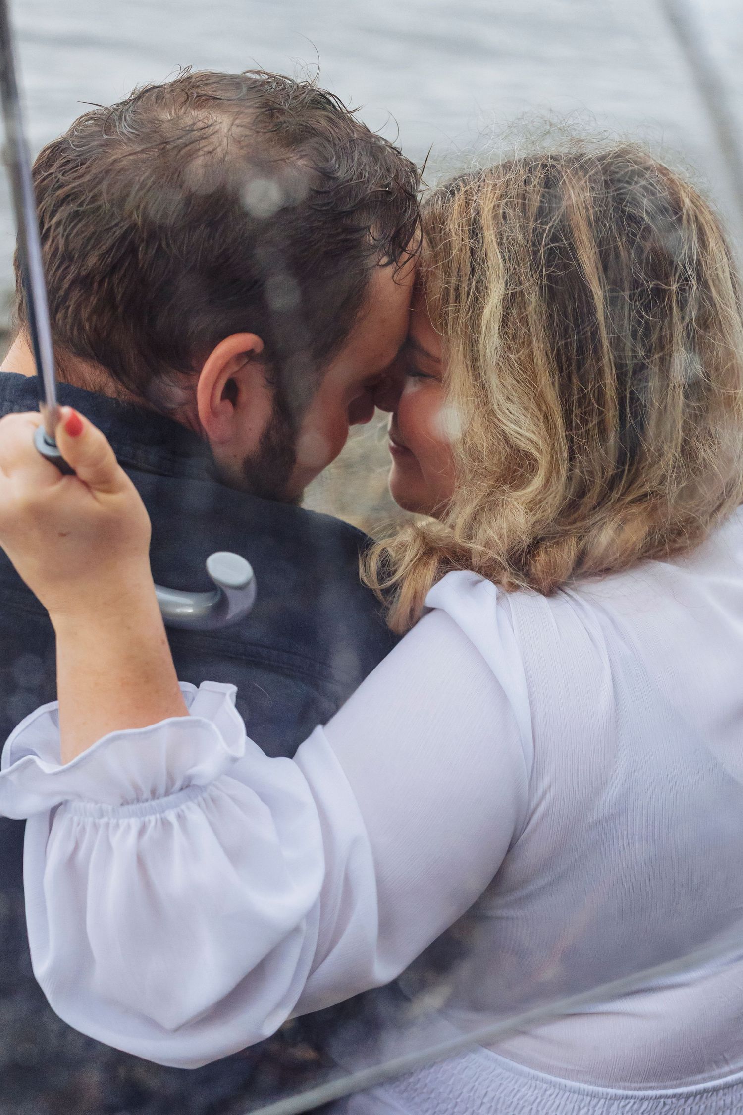 A sequence of photos showing two people in white and dark clothing embracing while looking out at a view together.