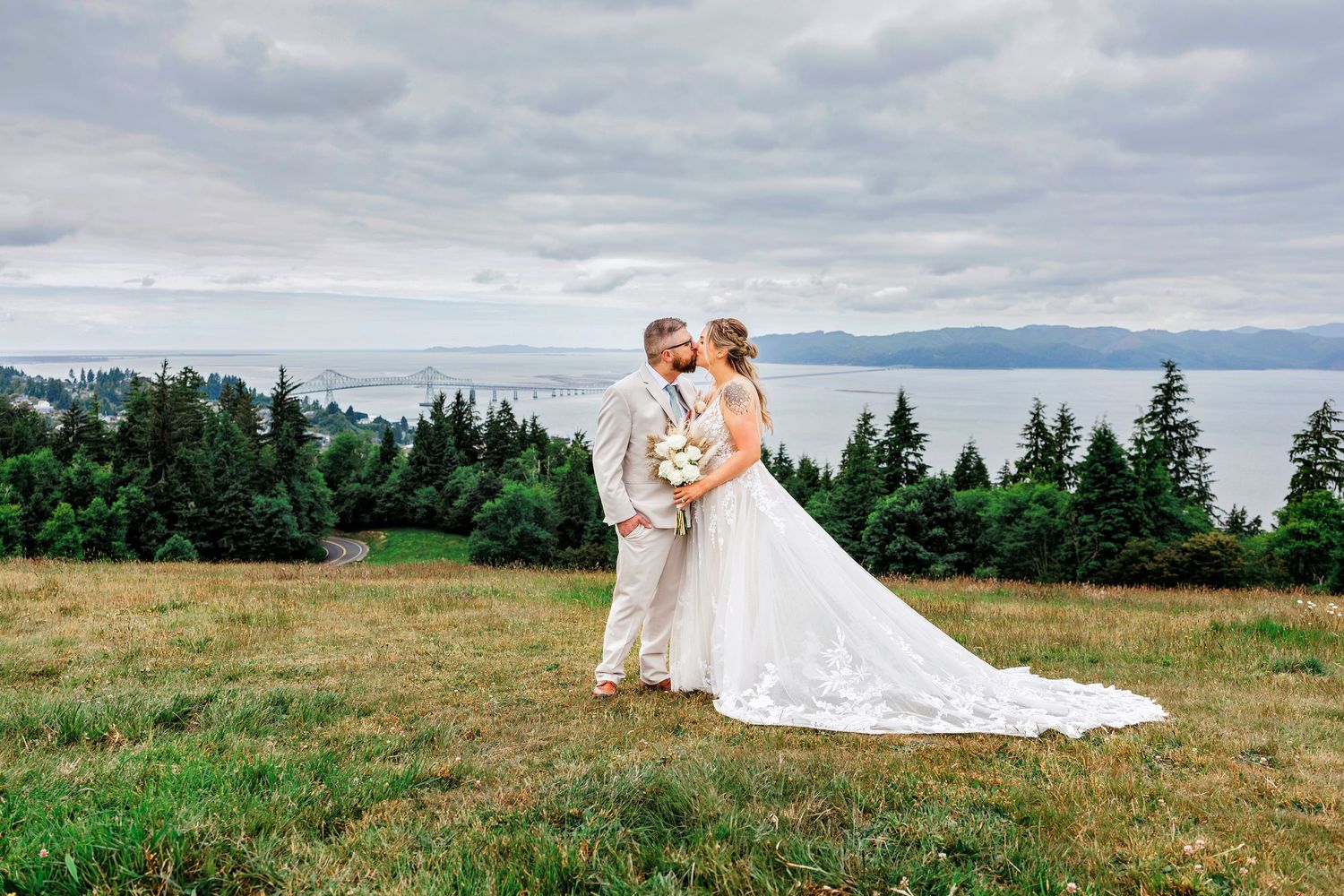Scenic hilltop wedding photos with mountain landscape in background.