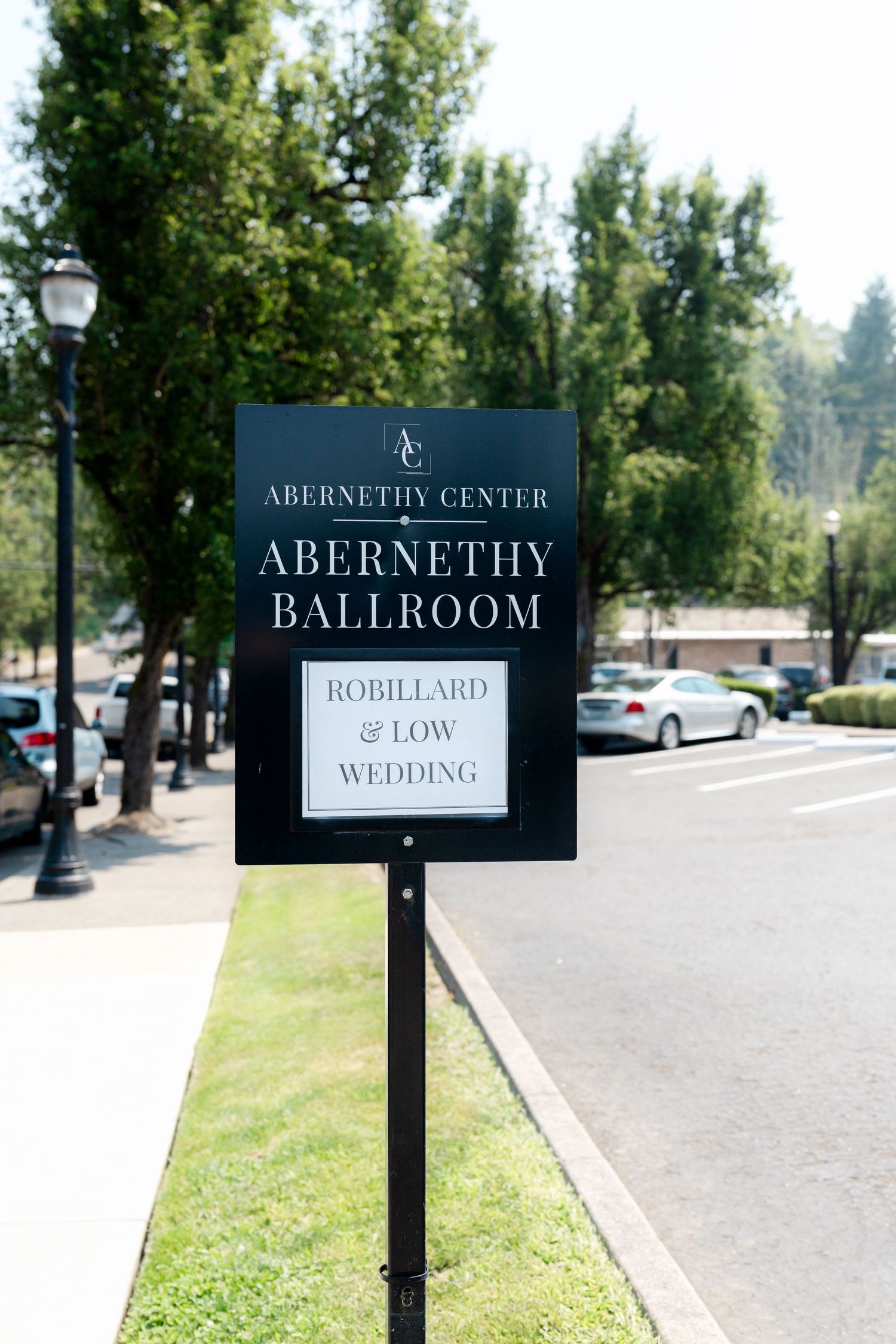 Sign for Abernethy Center Abernethy Ballroom announcing the Robillard and Low Wedding outdoors.