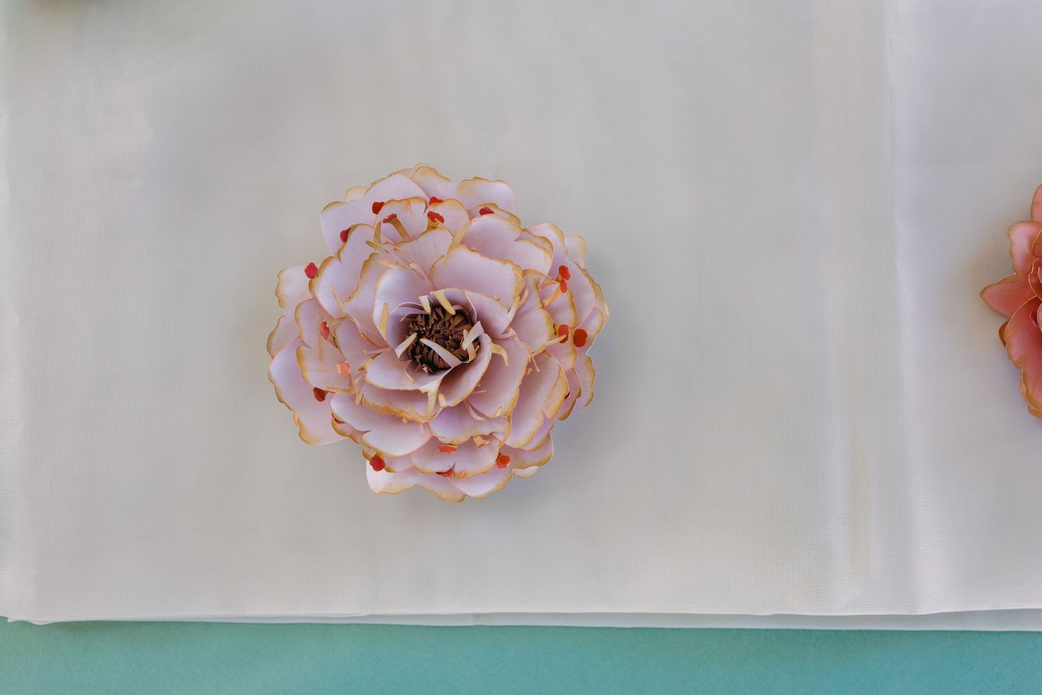 Delicate pink roses arranged on a white tablecloth.