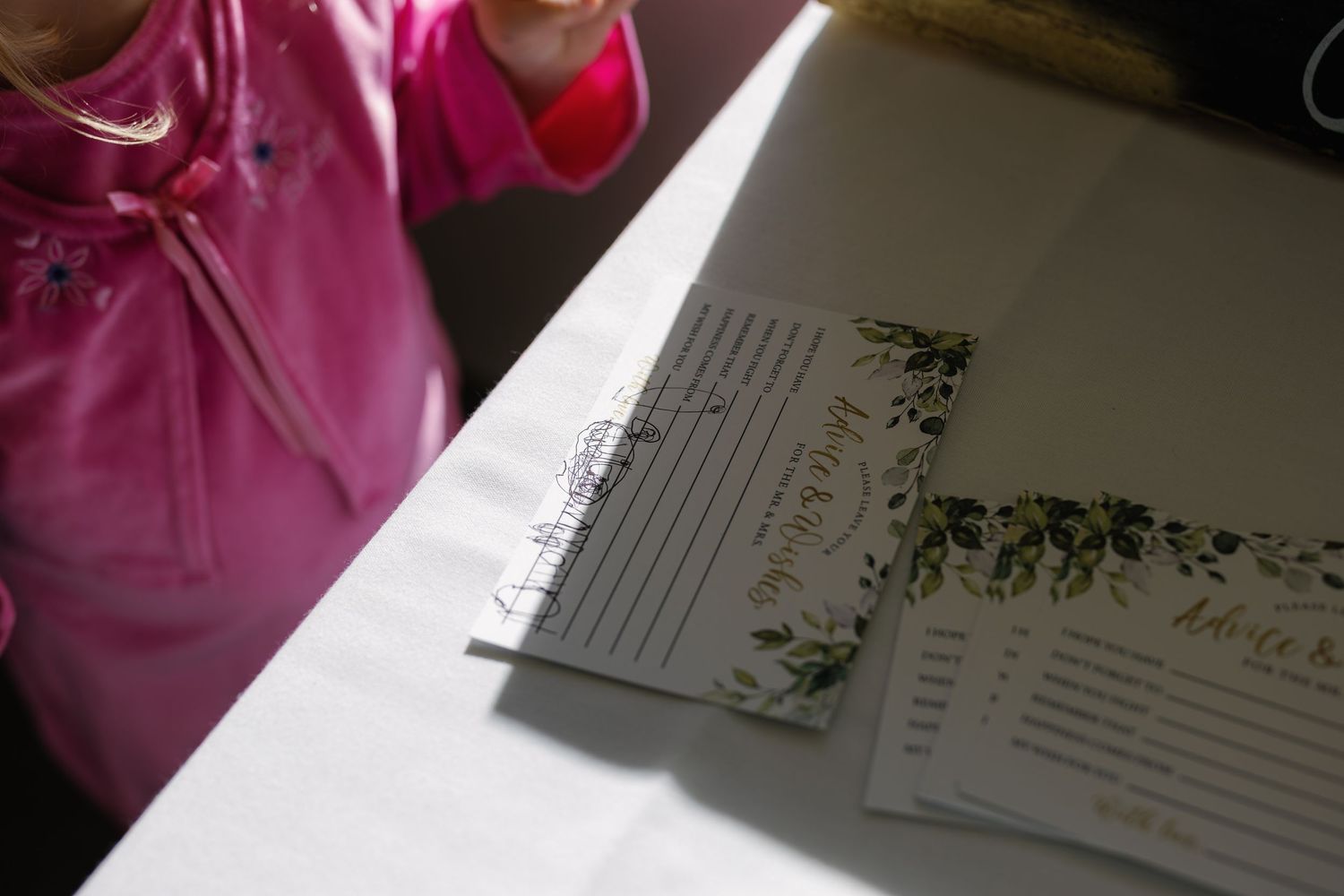 Wedding invitation suite and stationery with botanical designs and elegant details laid out on a white surface.