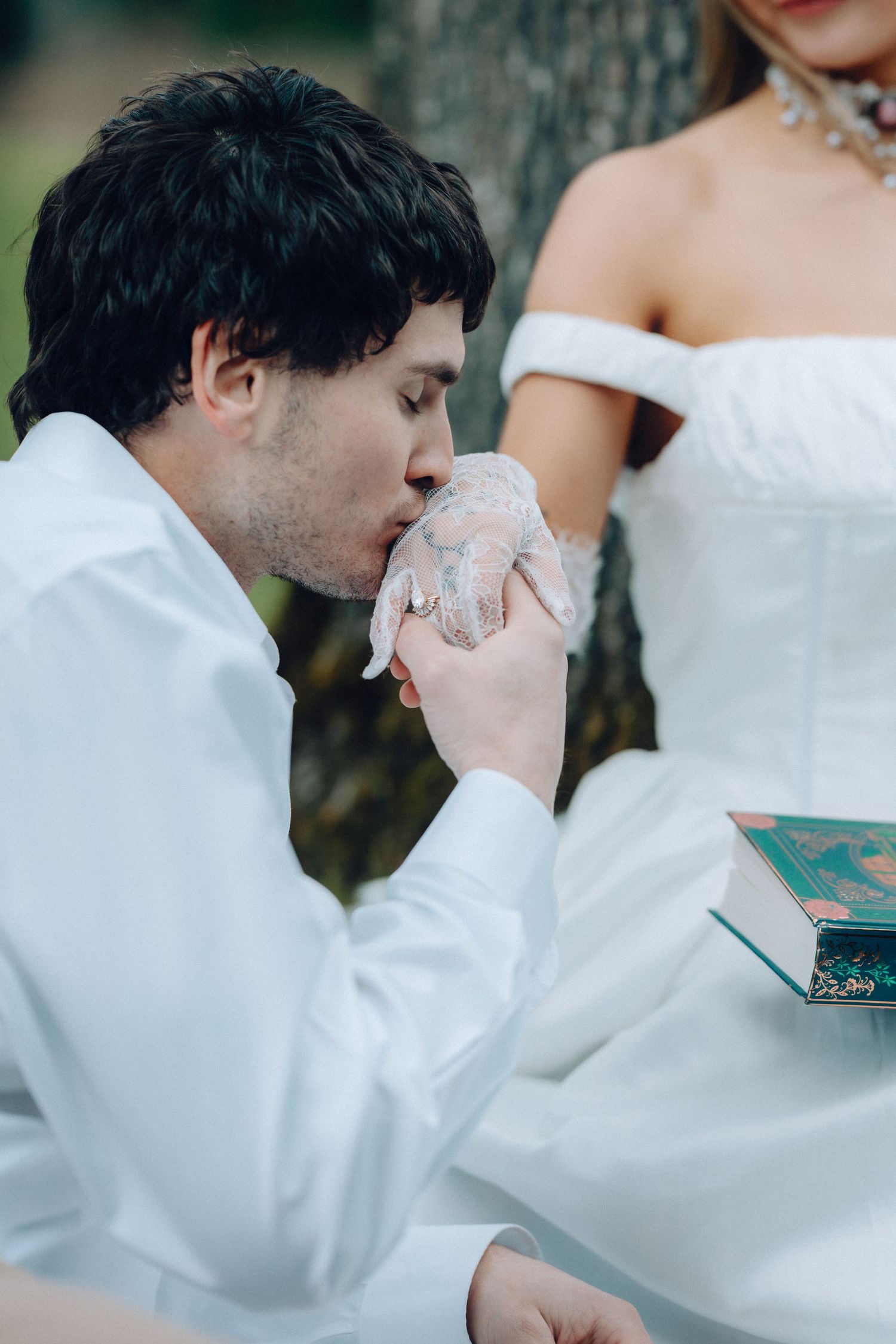 A series of emotional moments during a wedding ceremony as someone wipes away tears while wearing white formal attire.