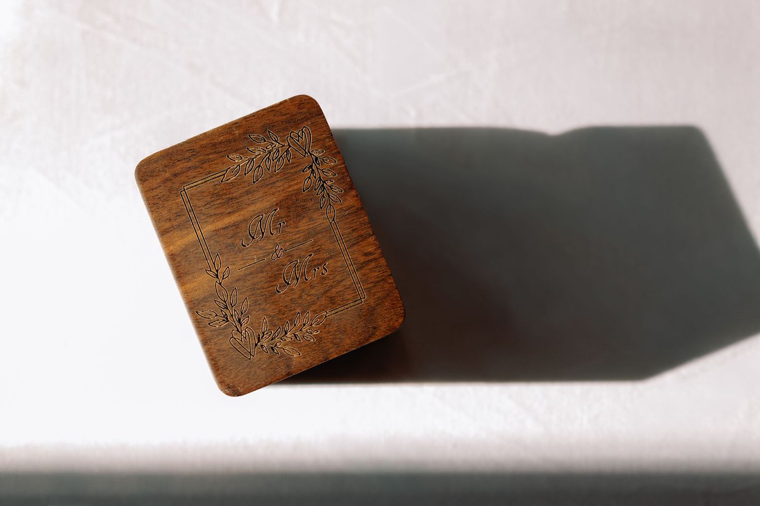 Wooden block casting a dramatic shadow on a white surface in different angles and positions.