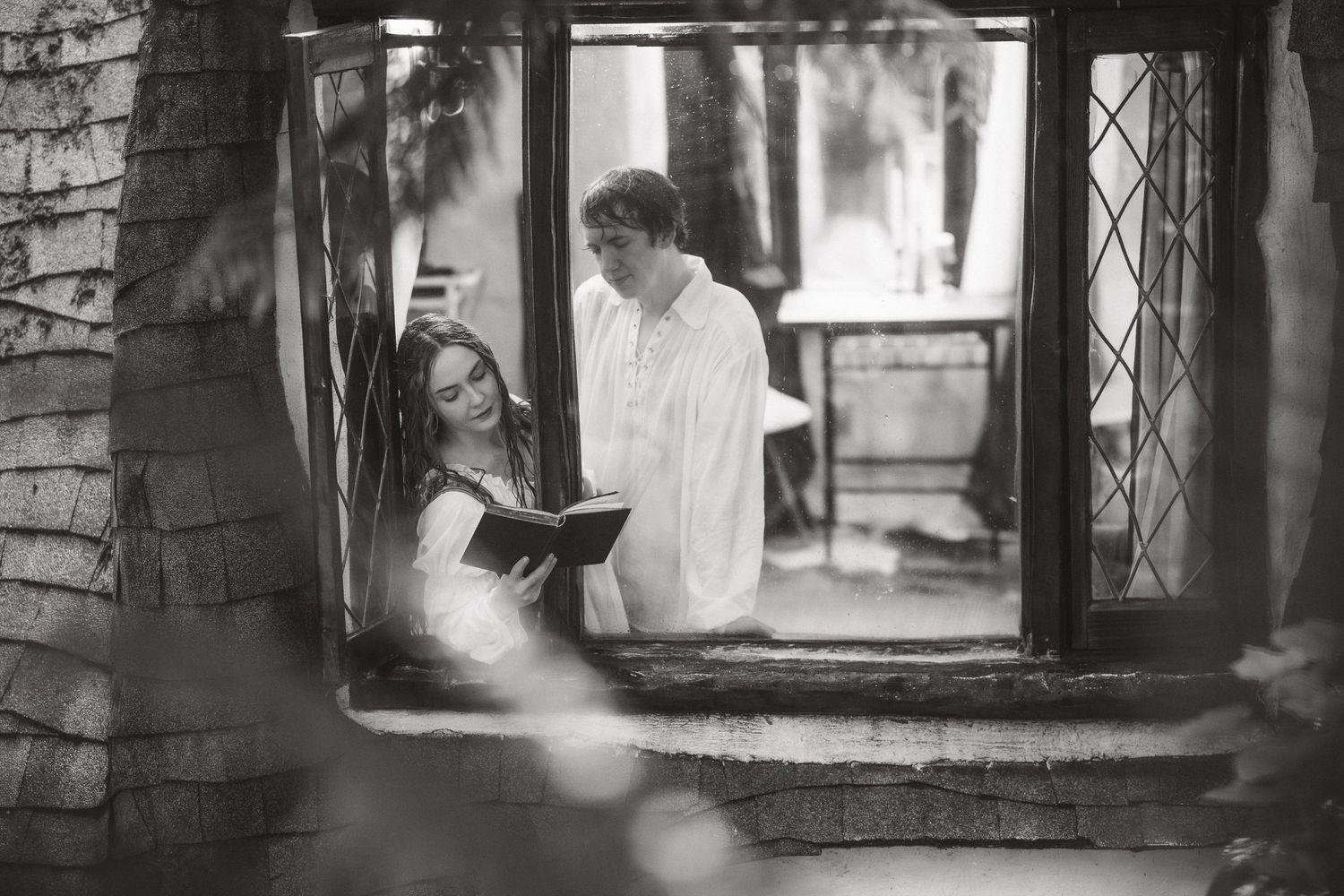 A series of vintage window frames showing silhouettes and romantic moments.