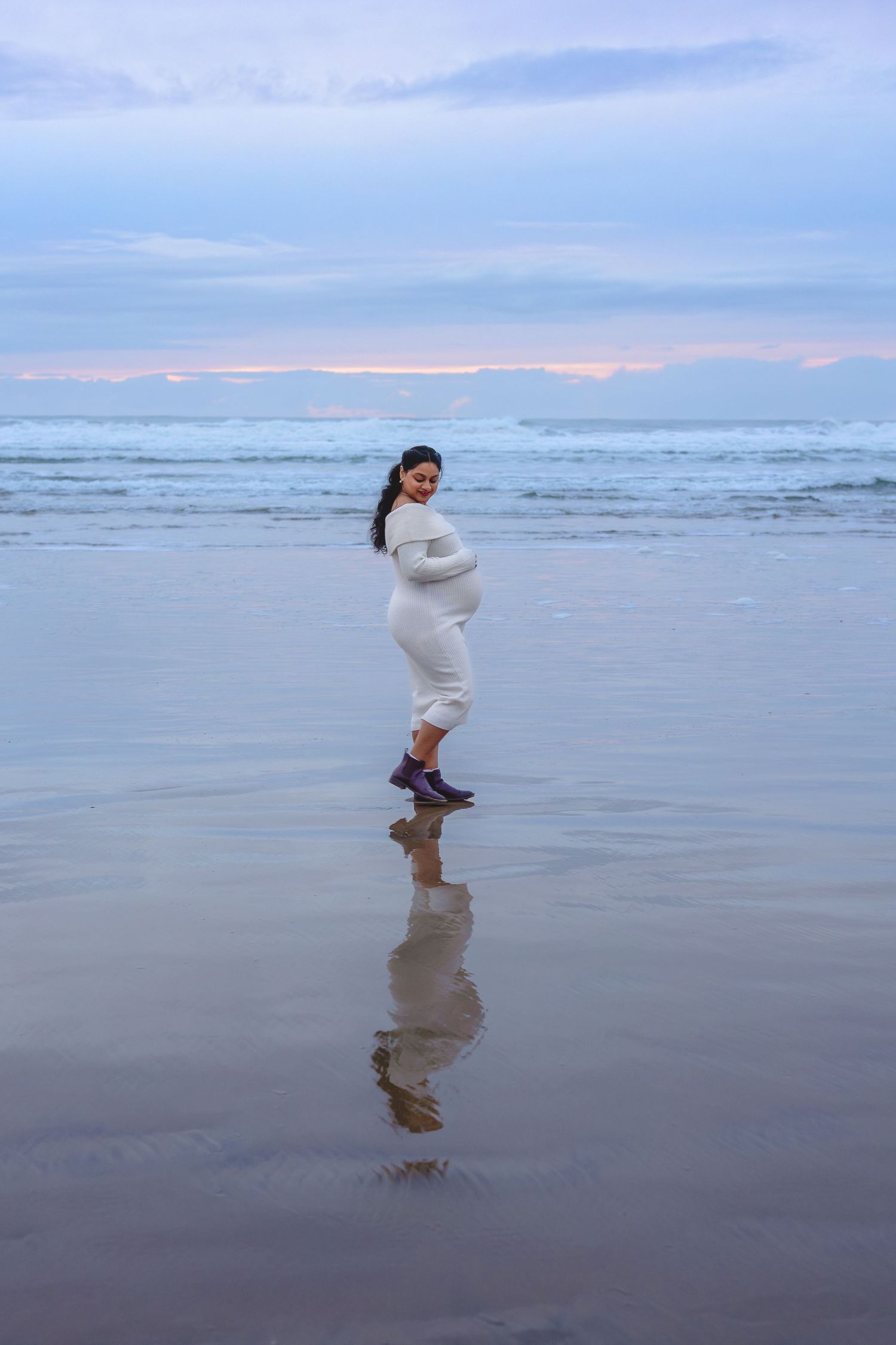 A sequence of photos showing someone in a white dress playfully jumping and dancing on a misty beach at sunset.
